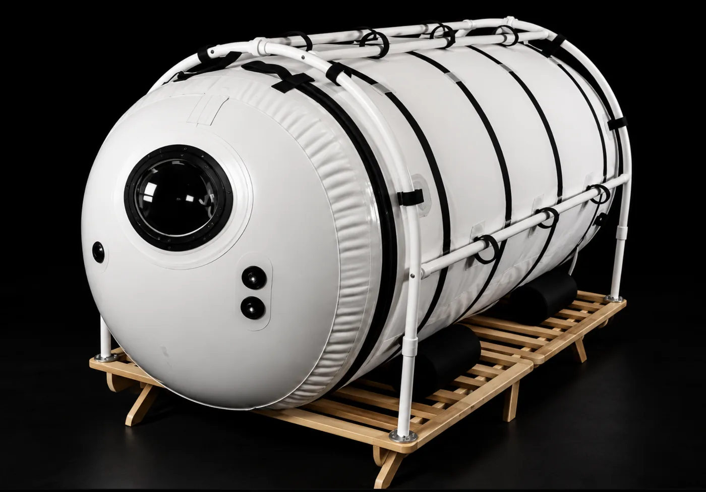 The Grand Dive Pro, the largest Summit to Sea horizontal mild hyperbaric chamber, on a wooden platform with a viewing port
