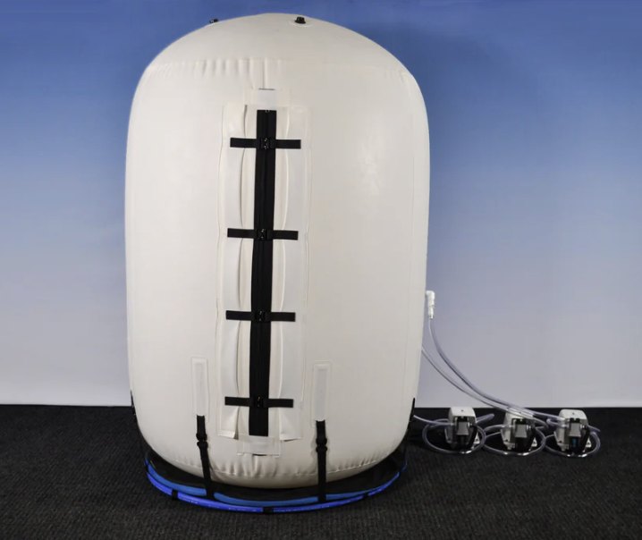 Summit to Sea upright mild hyperbaric oxygen chamber, rear view with zip entry and compressors